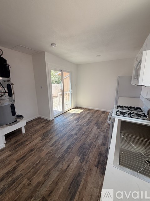 A kitchen with a stove and a washing machine.