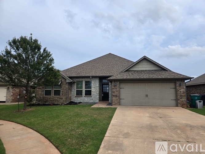 A house with a garage and a driveway in front.