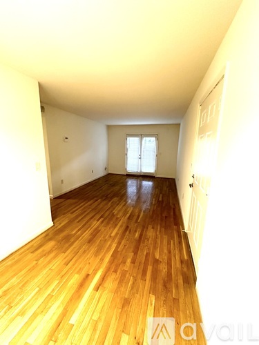 A room with wooden floors and a window.