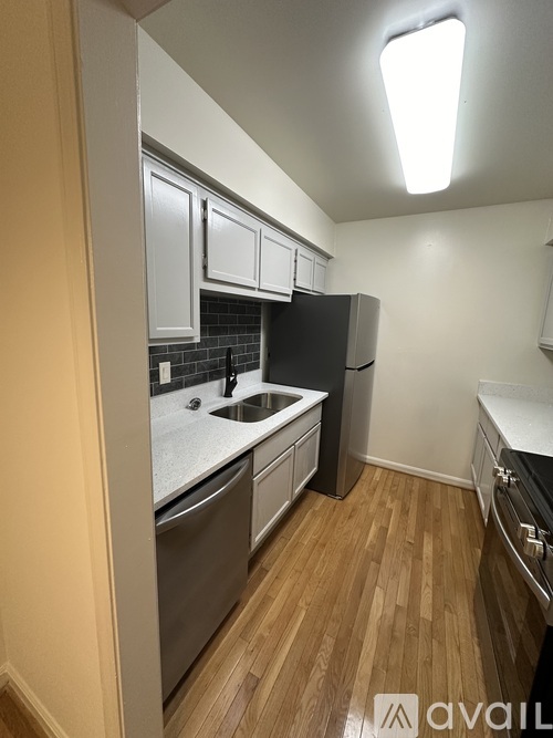 A kitchen with wooden floors and stainless steel appliances.
