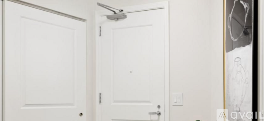 A white door with a silver handle and a silver door knob.