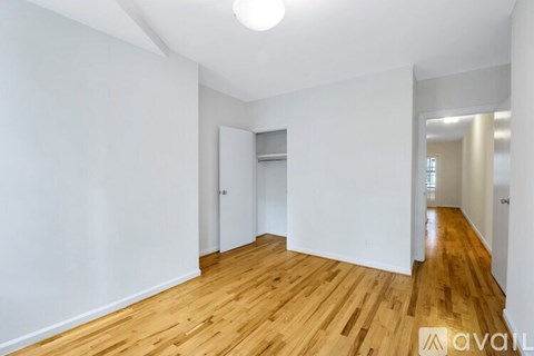 A room with wooden floors and white walls.