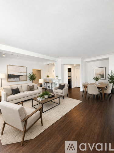 A living room with a white couch, a coffee table, and a dining table with chairs.