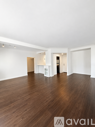 A room with wooden floors and white walls.