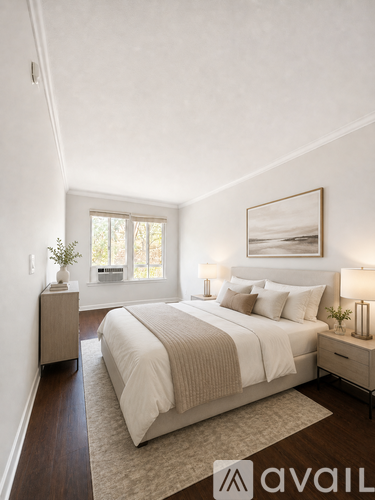 A bedroom with a large bed and a window.