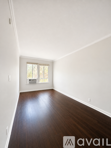 A room with wooden floors and a window.
