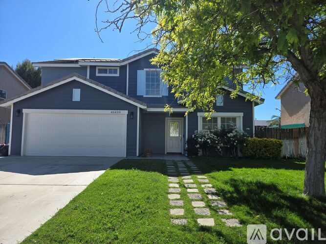 A house with a garage and a driveway with stepping stones.