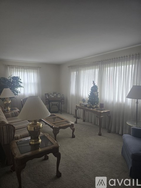 A living room with a sofa, a coffee table, and a side table with a lamp.