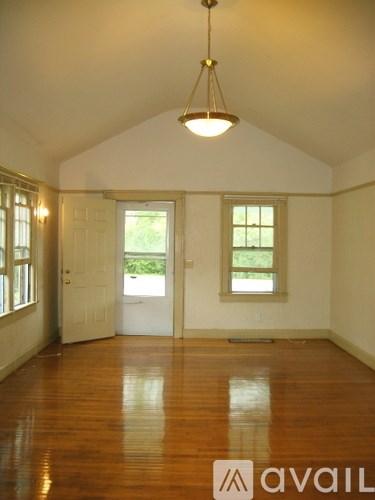A room with wooden floors and a white door.