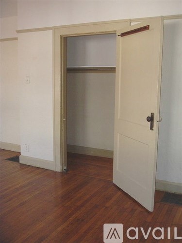 A room with a white door and a window.