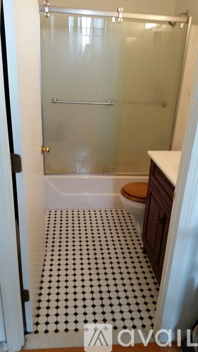 A bathroom with a black and white floor.