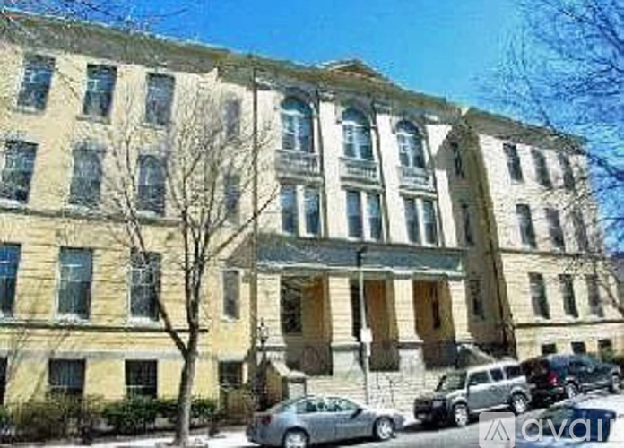 A large, old building with a row of windows on the ground floor.