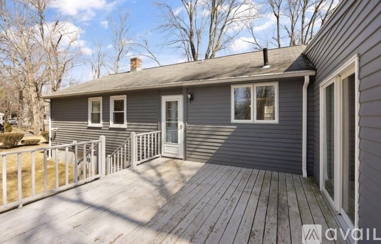 A house with a grey exterior and a wooden deck.