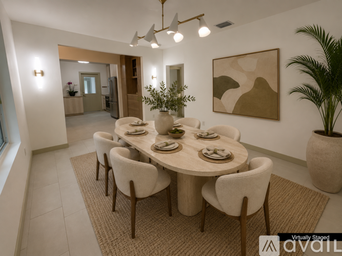 A dining room with a round table and chairs.