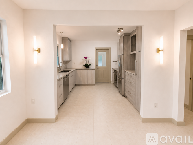 A spacious kitchen with white cabinets and a central island.