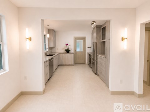 A spacious kitchen with white cabinets and a central island.