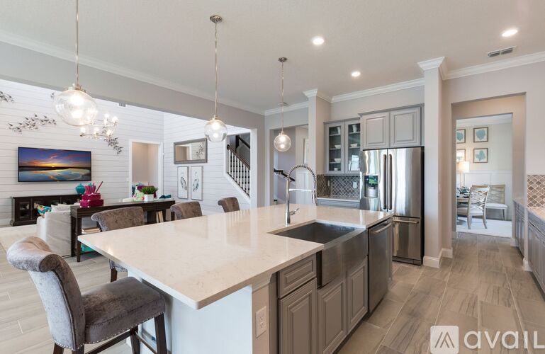 A modern kitchen with a large island and stainless steel appliances.