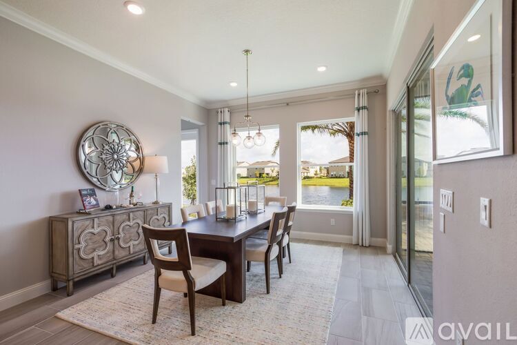 A dining room with a wooden table and chairs.