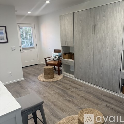 A room with a wooden floor and a white door.