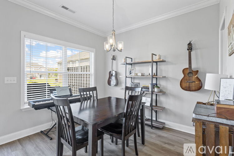 A dining room with a wooden table and chairs.