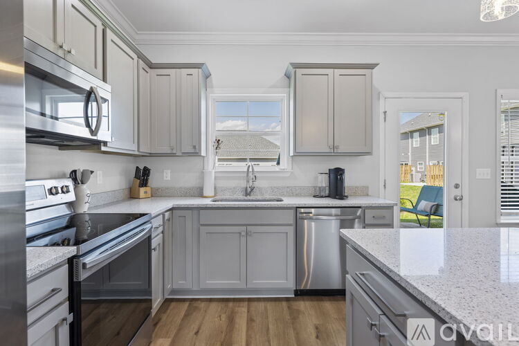 A kitchen with a stainless steel oven and a white countertop.