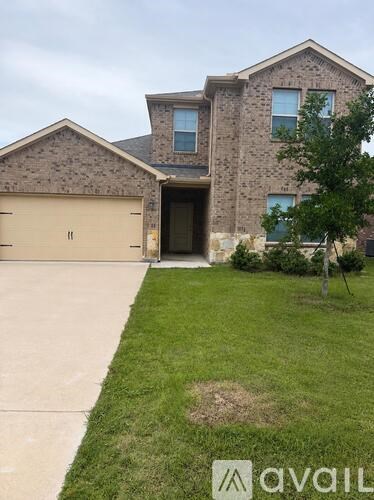 A house with a garage and a driveway in front.