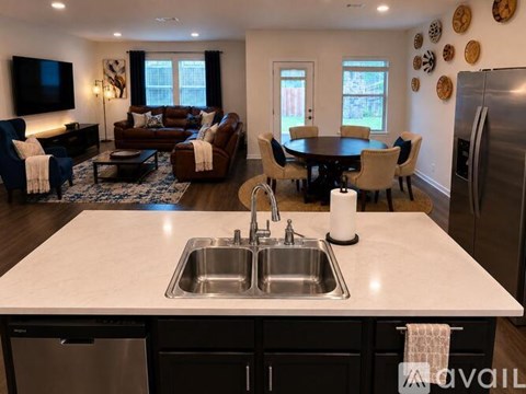 A modern kitchen with a dining table and chairs.