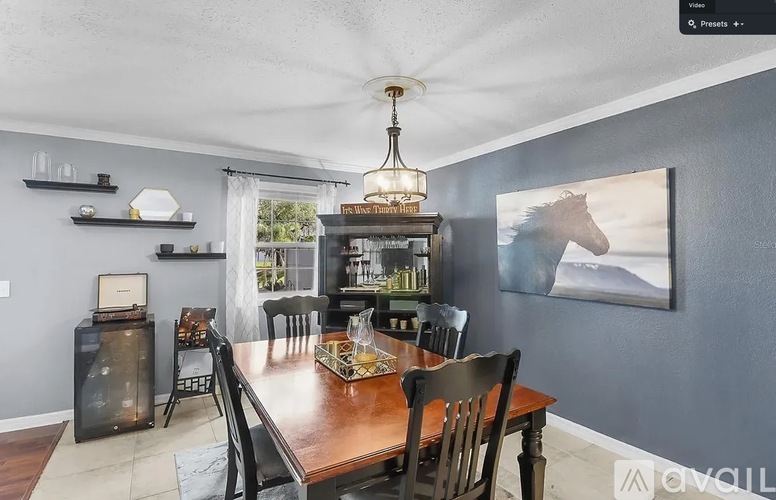A dining room with a wooden table and chairs.
