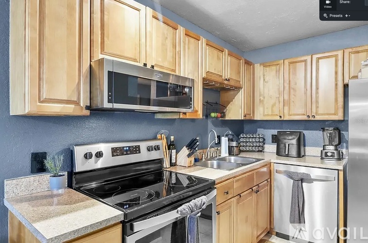 A kitchen with wooden cabinets and stainless steel appliances.