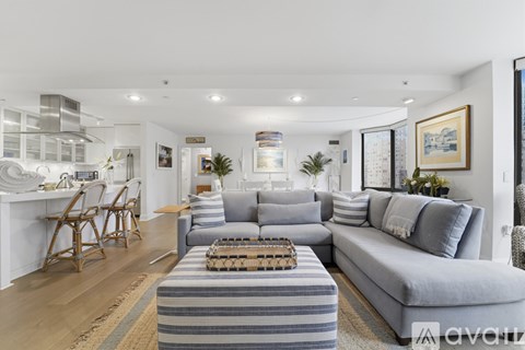 A living room with a grey sofa and a wooden table.