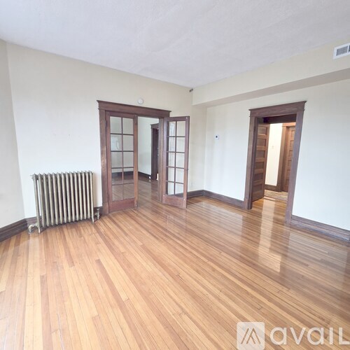 A room with wooden floors and a radiator.