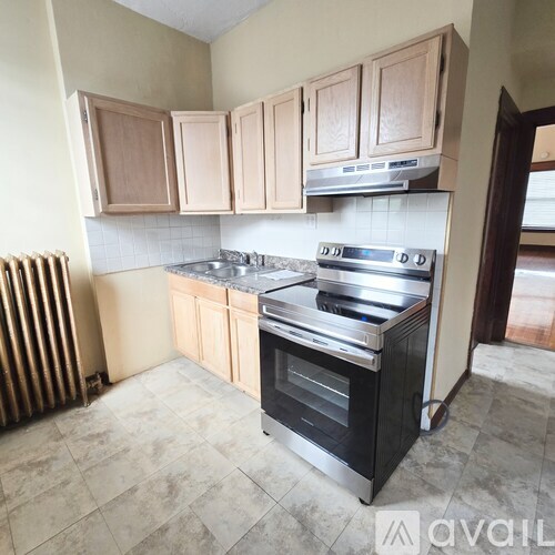 A kitchen with wooden cabinets and a stainless steel stove.