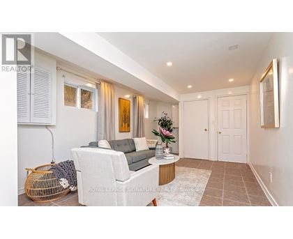 A living room with a white sofa and a wooden coffee table.