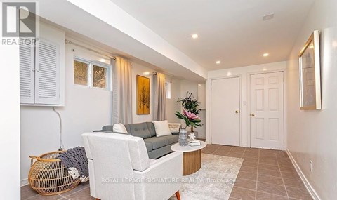 A living room with a white sofa and a wooden coffee table.