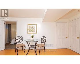 A dining room with a glass table and chairs.