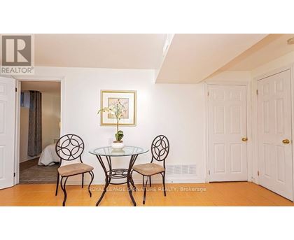 A dining room with a glass table and chairs.