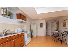 A kitchen with wooden cabinets and a white fridge.