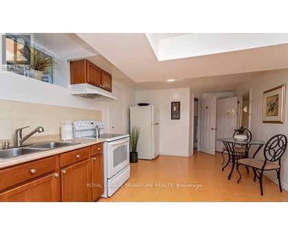 A kitchen with wooden cabinets and a white fridge.