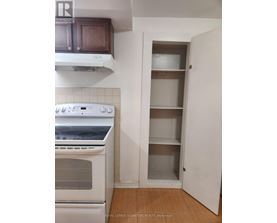 A white oven in a kitchen with a white cabinet and a white door.