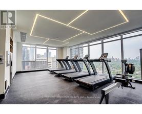 A gym with treadmills and a view of the city.
