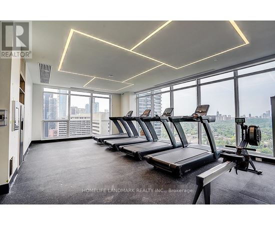 A gym with treadmills and a view of the city.