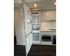 A white refrigerator with its door open in a kitchen.