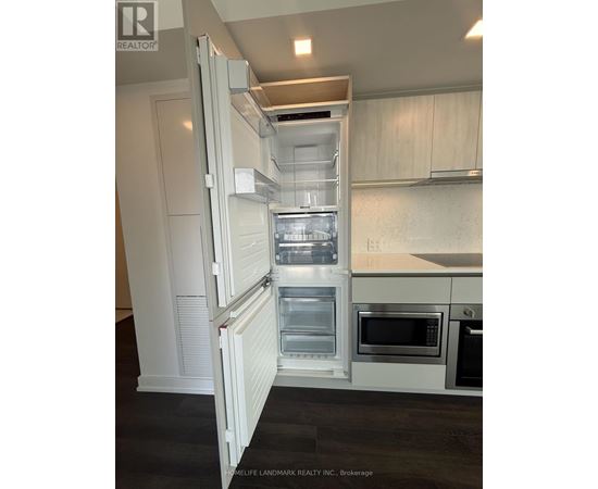 A white refrigerator with its door open in a kitchen.