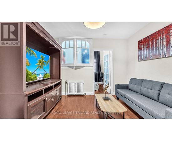 A living room with a grey couch and a wooden coffee table.