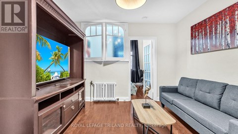 A living room with a grey couch and a wooden coffee table.
