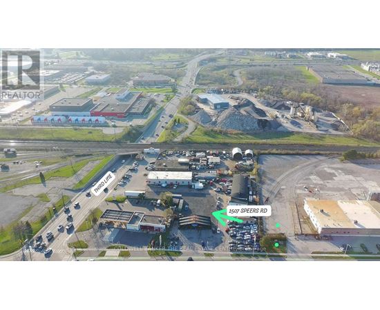 An aerial view of a construction site with a green arrow pointing to 1597 Speers Rd.