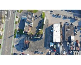 An aerial view of a parking lot with cars and buildings.