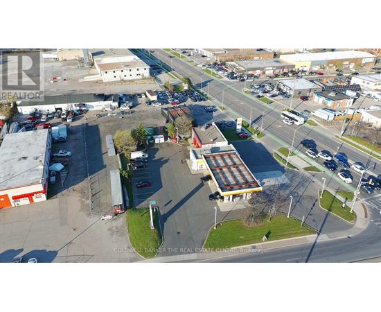 An aerial view of a parking lot with a building in the middle.