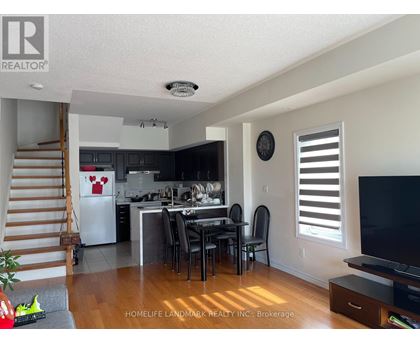 A kitchen with a dining table and chairs in the middle of the room.