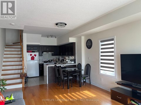 A kitchen with a dining table and chairs in the middle of the room.